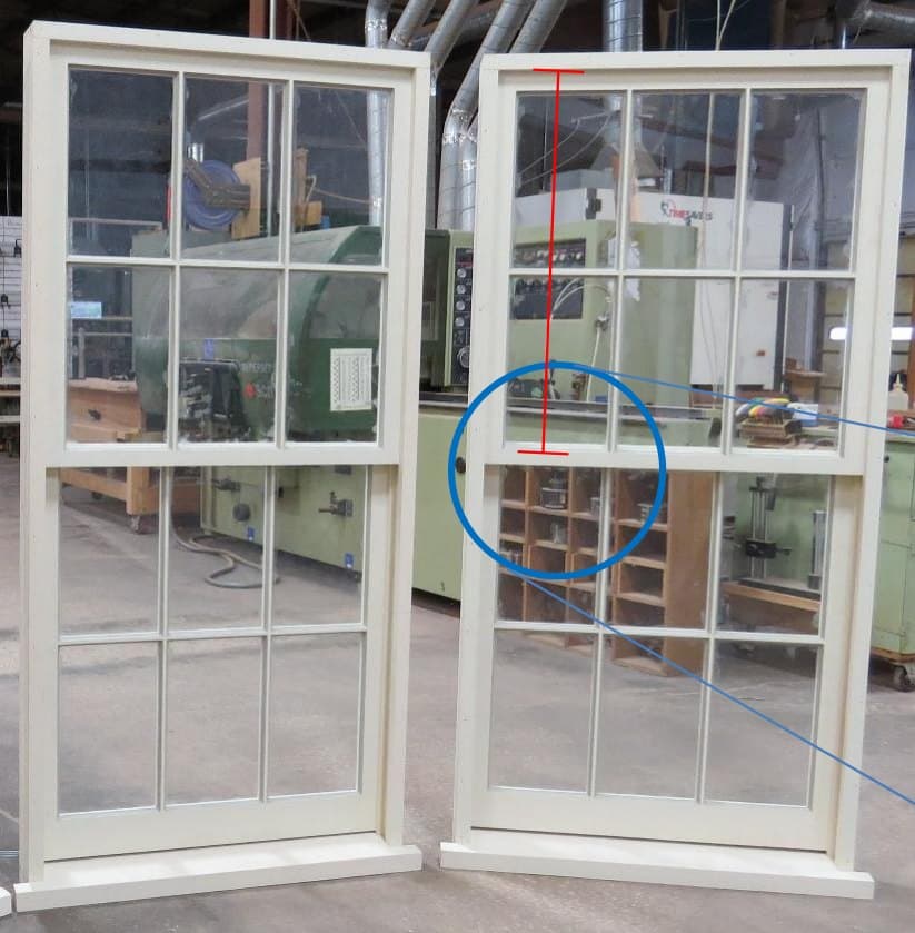 Two painted double-hung windows with the meeting rail circled where the upper and lower sash meet
