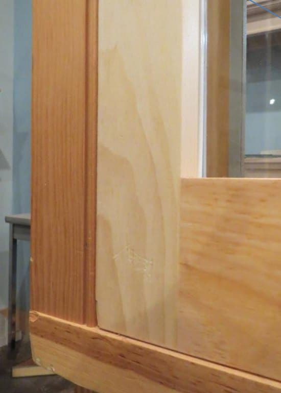 Wood storm window sitting against the blind stop, viewed from the exterior