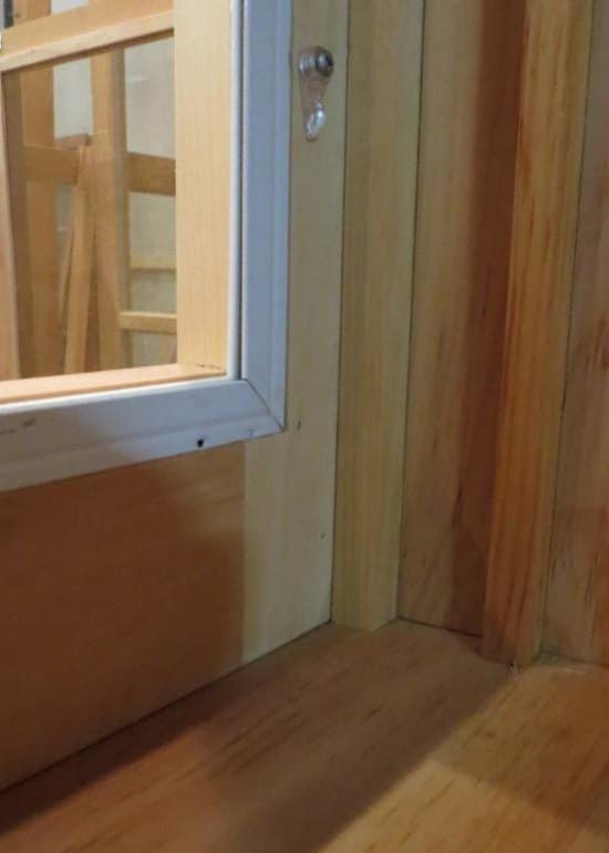 Wood storm window sitting against the blind stop, viewed from the interior