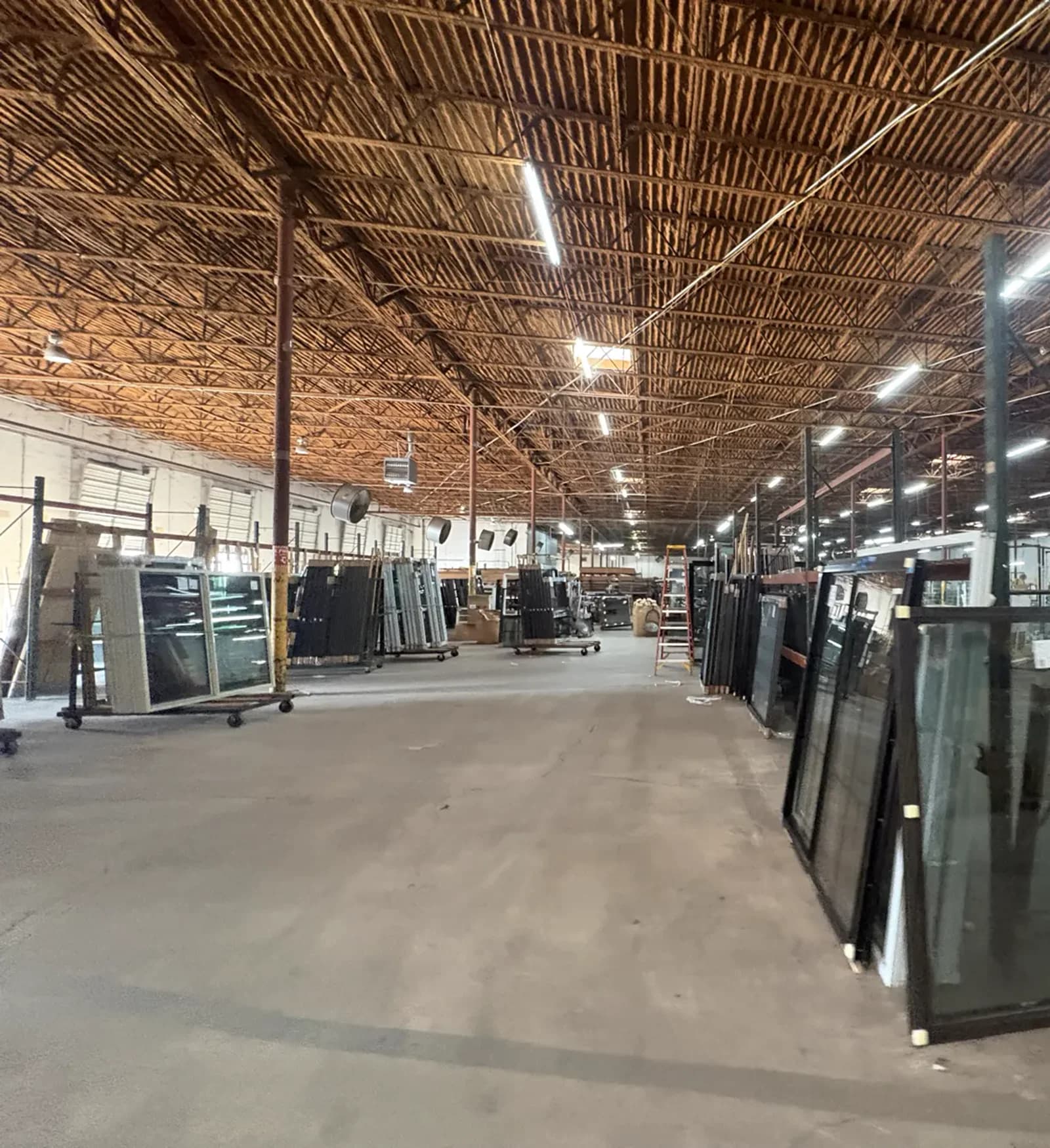 Custom storm windows lined up on the production floor