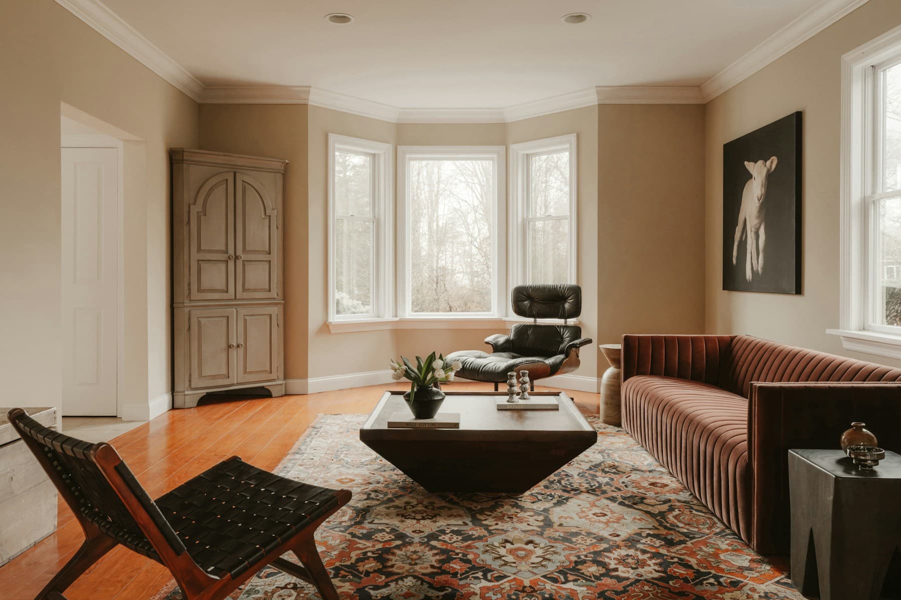 Warm living room with tall sash windows and a bay window
