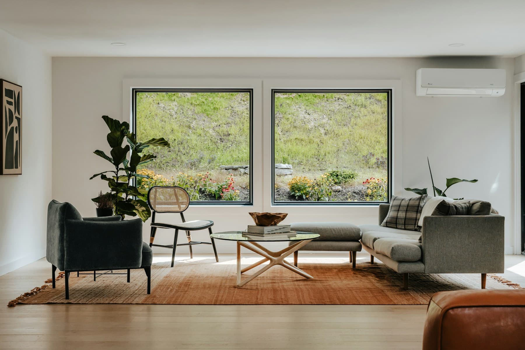 Bright contemporary living room with two large picture windows