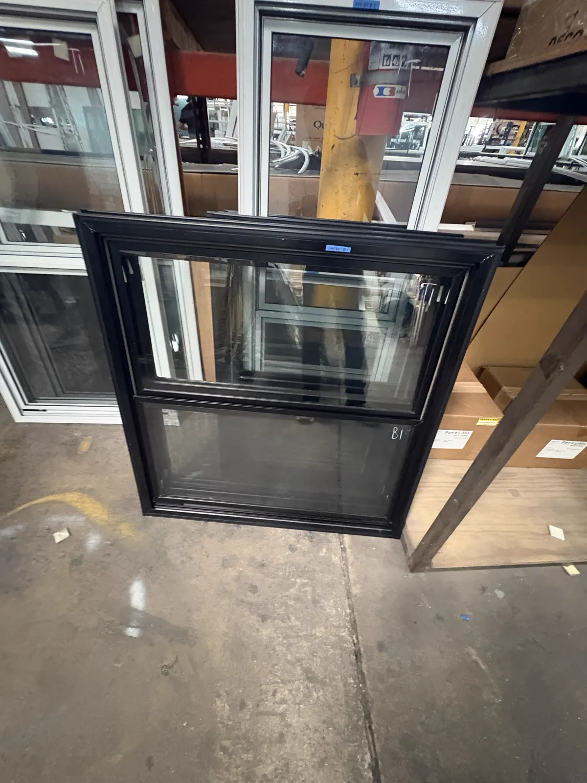 Actual black vertical storm window with exterior half screen