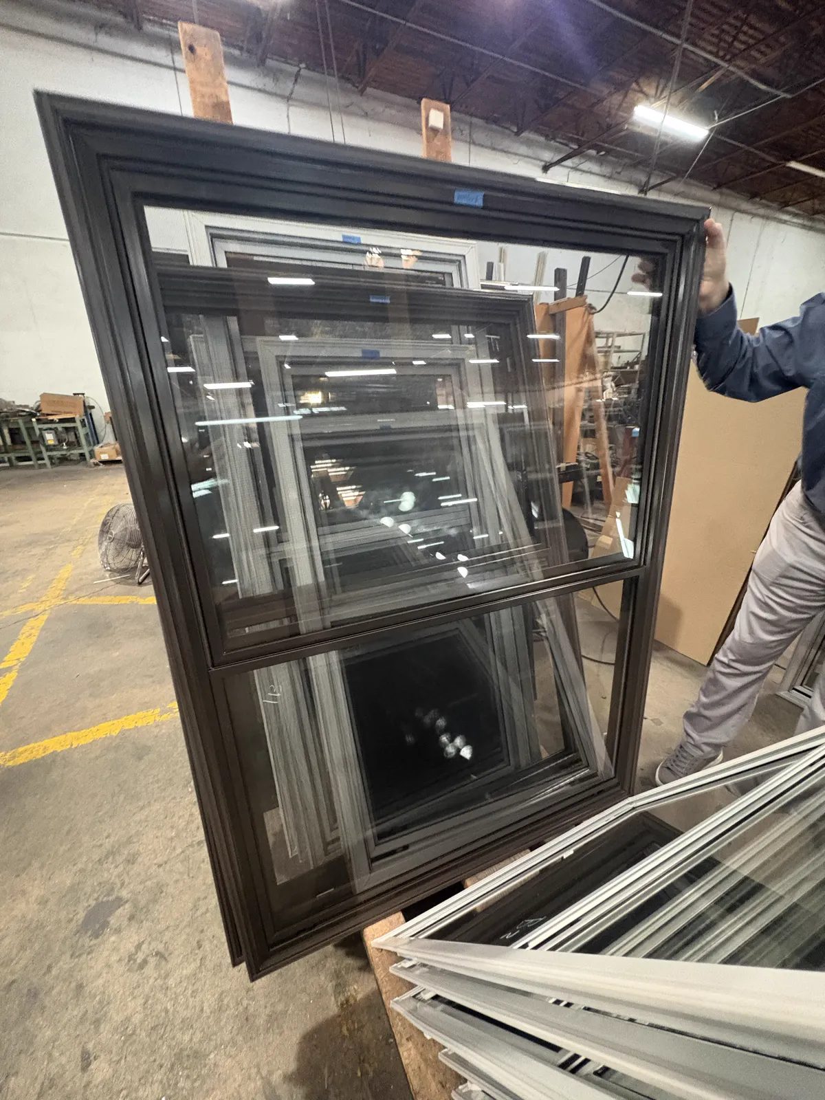 Actual black half-screen storm window viewed in the shop