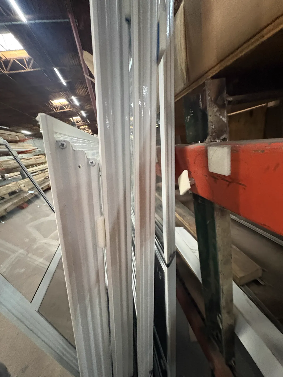Close-up of a black tubular storm window frame and track