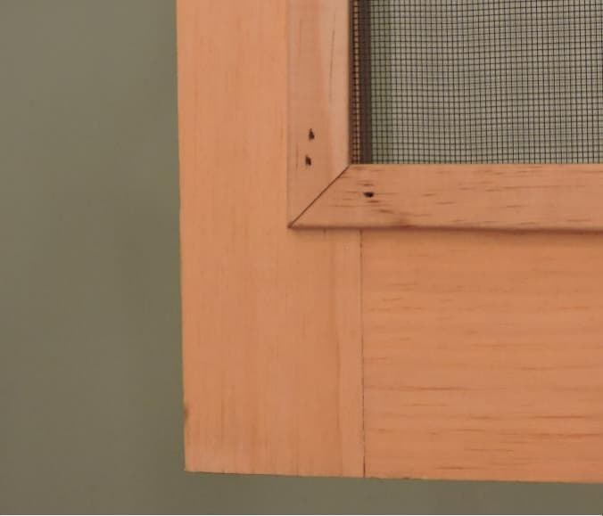 Combination wood storm window stile meeting the bottom rail