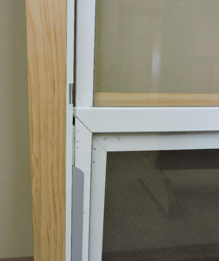 Self-storing wood storm window center bar and track from the interior