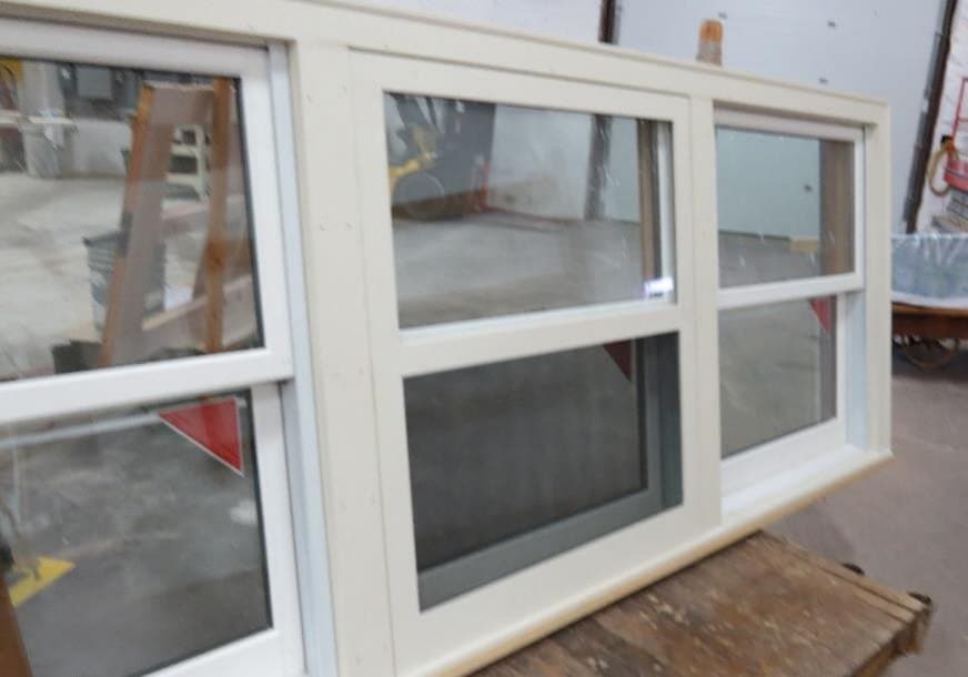 Row of painted self-storing wood storm windows