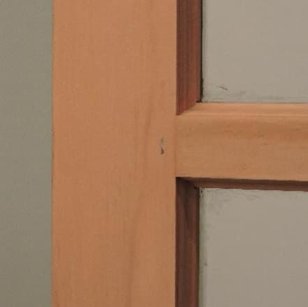 Bottom rail of a traditional wood storm window viewed from the interior