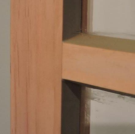 Traditional wood storm window center bar viewed from the exterior