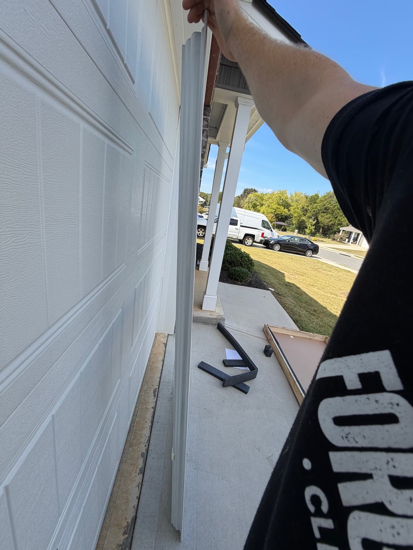 Customer checking the side profile of a delivered storm door