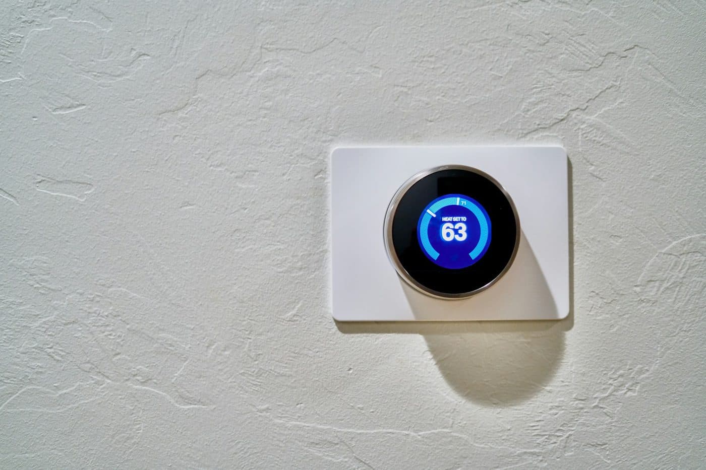 A wall thermostat showing the indoor temperature