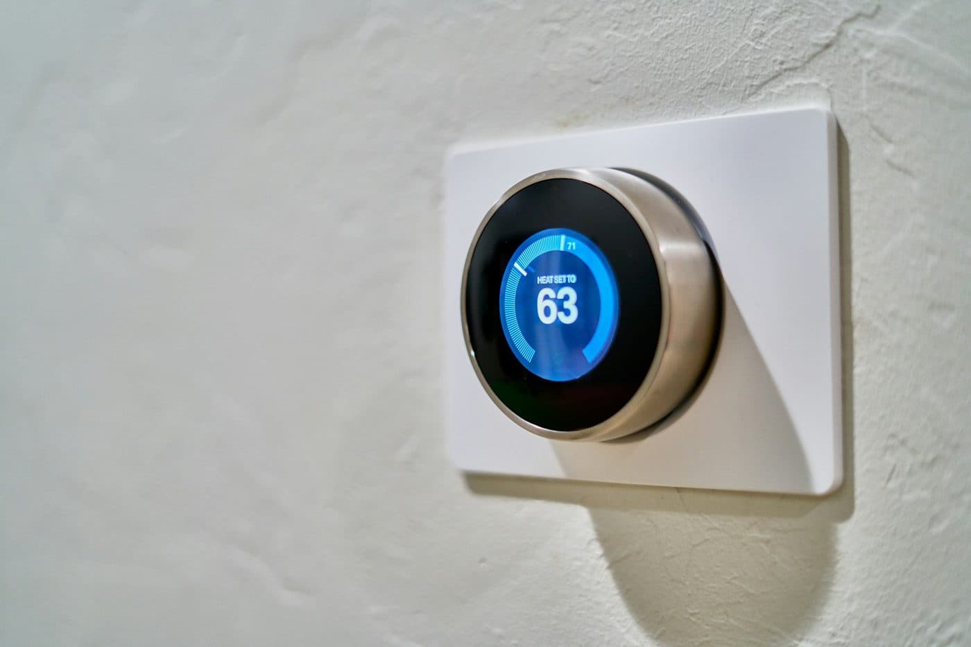 A smart thermostat on a textured wall