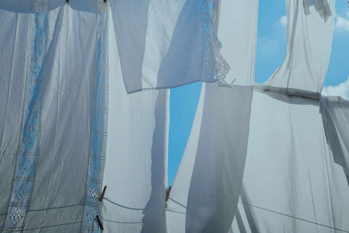 Light curtains moving in a breeze at an open window