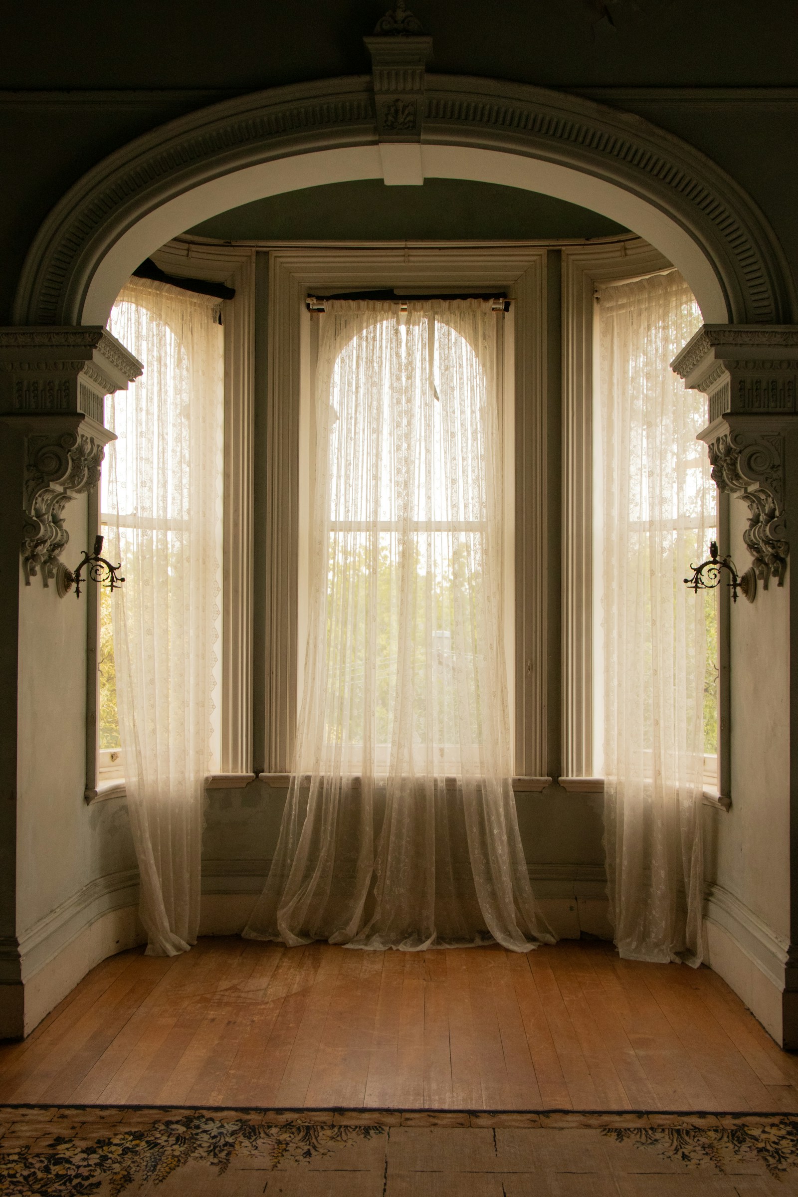 Tall original windows extending close to the floor in a historic home interior